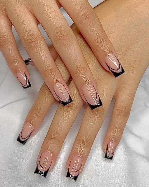 Black French tip nails with swirl line accents