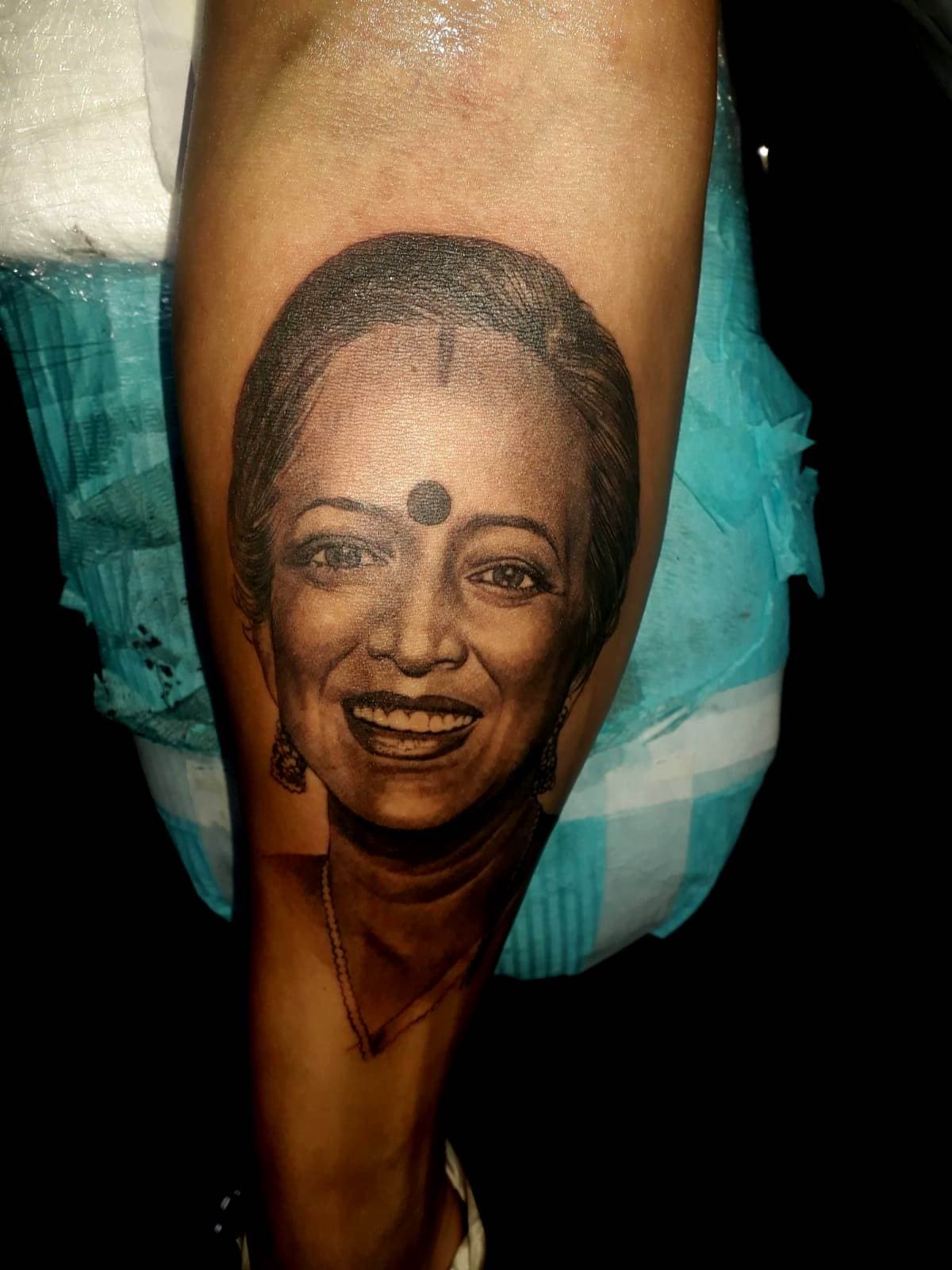 Realistic black and grey portrait tattoo on forearm
